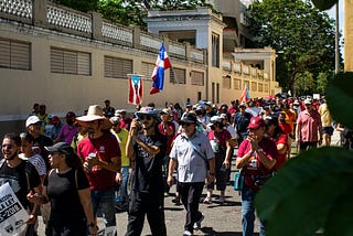 People march with Puerto Rican flags