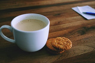 A cup of tea and cookies on a table