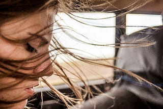 woman looking through the car window