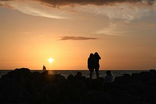 silhouettes of two girls at sunset.