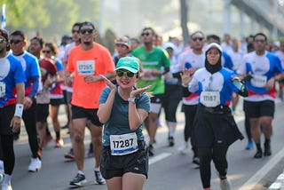 Photo of smiling woman in a race framing her face with her hands