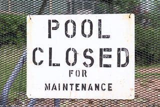 Sign: “Pool Closed for Maintenance”