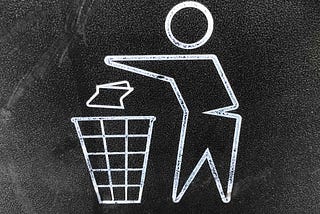 a chalkboard drawing of a person throwing something in the trash can