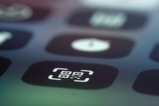 A qr code scanner icon on screen of a mobile device