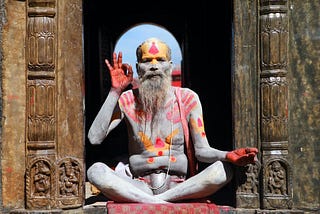 A colorfully painted man sitting in Nepal