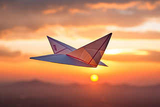 Close-up photo-style image of a paper airplane aloft at sunset with distant mountain range on the horizon