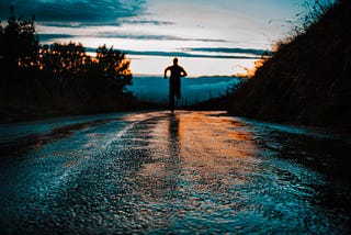 Man running on a street away from the camera