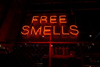 Neon sign reading “Free Smells”