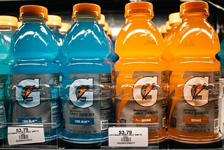 close up on 4 rows of Gatorade for sale in a refrigerator at a grocery store.