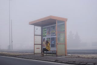 Woman alone on a bus station.