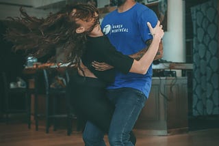 A couple salsa dancing