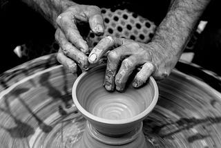 A potter making clay pot of a certain design.
