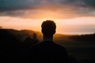 Man watching Muriwai sunset