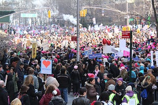Photo of a large protest of women in the streets, many holding protest signs.