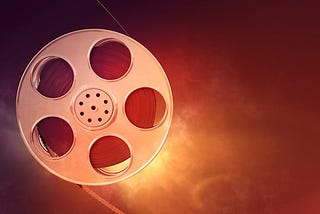 A Sparking Cinema Film Reel Against A Blank Background