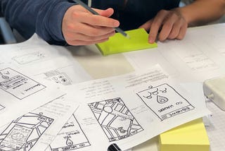 a person sitting down to draw out prototypes