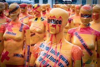 mannequins wrapped in tape with the words, ‘justice,’ ‘do not look away,’ and ‘#metoo’ as part of an art installation about violence against women.