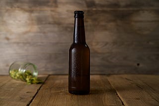 A beer bottle and a fallen jar