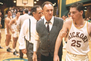 Coach Dale gruffly grabs his player. Hoosiers