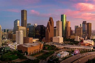 Picture of the city of Houston with tall buildings and highways