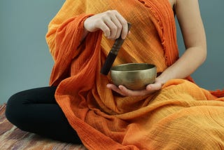 A Buddhist monk uses a singing bowl