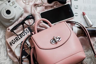 Pink purse with contents spilling out. I just wish my daughter would carry one!