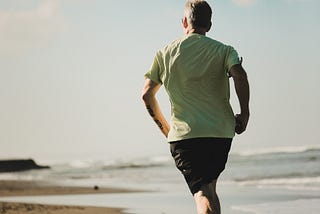 A man running on the beach.