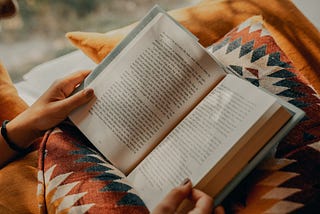 Reading a book on a sunny day with a warm blanket