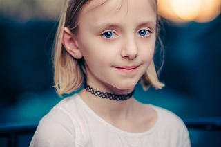 Blue-eyed, blonde girl looking into the camera