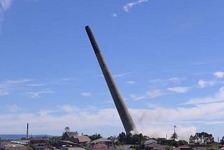 Physics Paradox? Falling Tower Outruns Free Fall