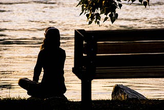 silhouette of woman overlooking the water