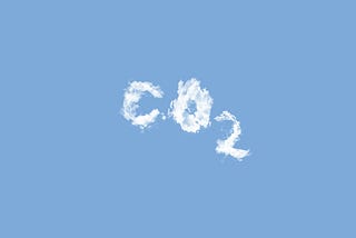 A blue sky with letters written in clouds to spell “CO2.”