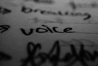 a closeup of the word “voice” written in black ink