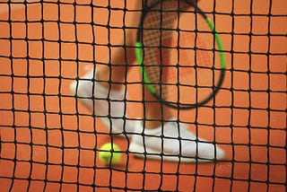 Tennis player with racket, ball and net