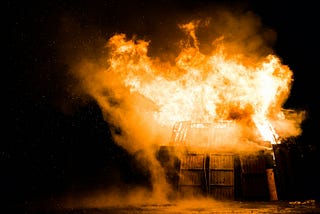 Nighttime blaze engulfs wooden structure — symbolizing the destructive impact of fireworks-related arson and the civilian trauma explored in “Legal Terrorism.”