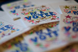 Handmade notes that say “Be a Voter”.”