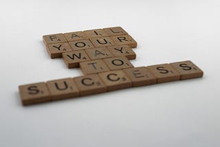 Scrabble Letters Spelling Out “Fail Your Way To Success”