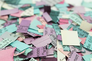 bunch of little pieces of white, lilac and blue papers, to symbolize abundance