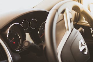 Interior shot of a steering wheel and dash