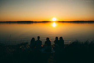 A family of 5 enjoying sunset