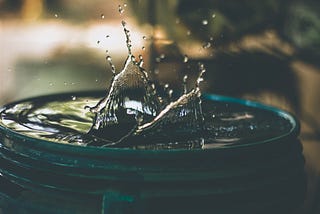 Water splashing in a container filled up to the brim.