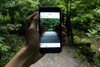 Person Holding Smartphone Taking Picture of Bridge during Daytime. One of the perks of deleting Instagram was eliminating the desperate need to ‘capture’ moments so I could share them later. I Quit Social Media for 365 Days To Improve My Mental Health — Here’s What Happened