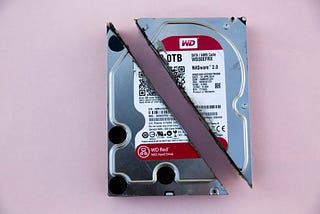 A physical hard drive disk destroyed by cutting it in half diagonally  . Backup files with rclone
