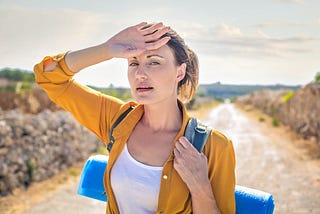 Woman in Yellow Long Sleeve Carrying Blue Yoga Mat