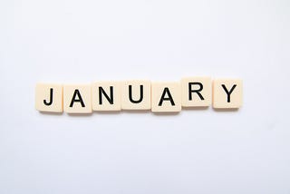 The word “January” spelled in letter tiles