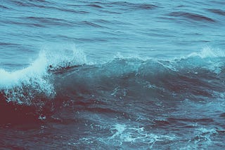 An ocean wave cresting.