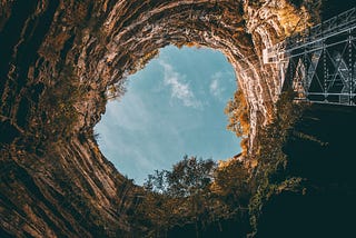 looking up at the sky from a deep hole