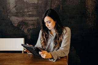 A young woman looking at a tablet computer