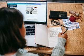 a lady writing down notes on her notepad