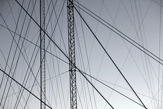 A photo of pylons with high tension wires between them